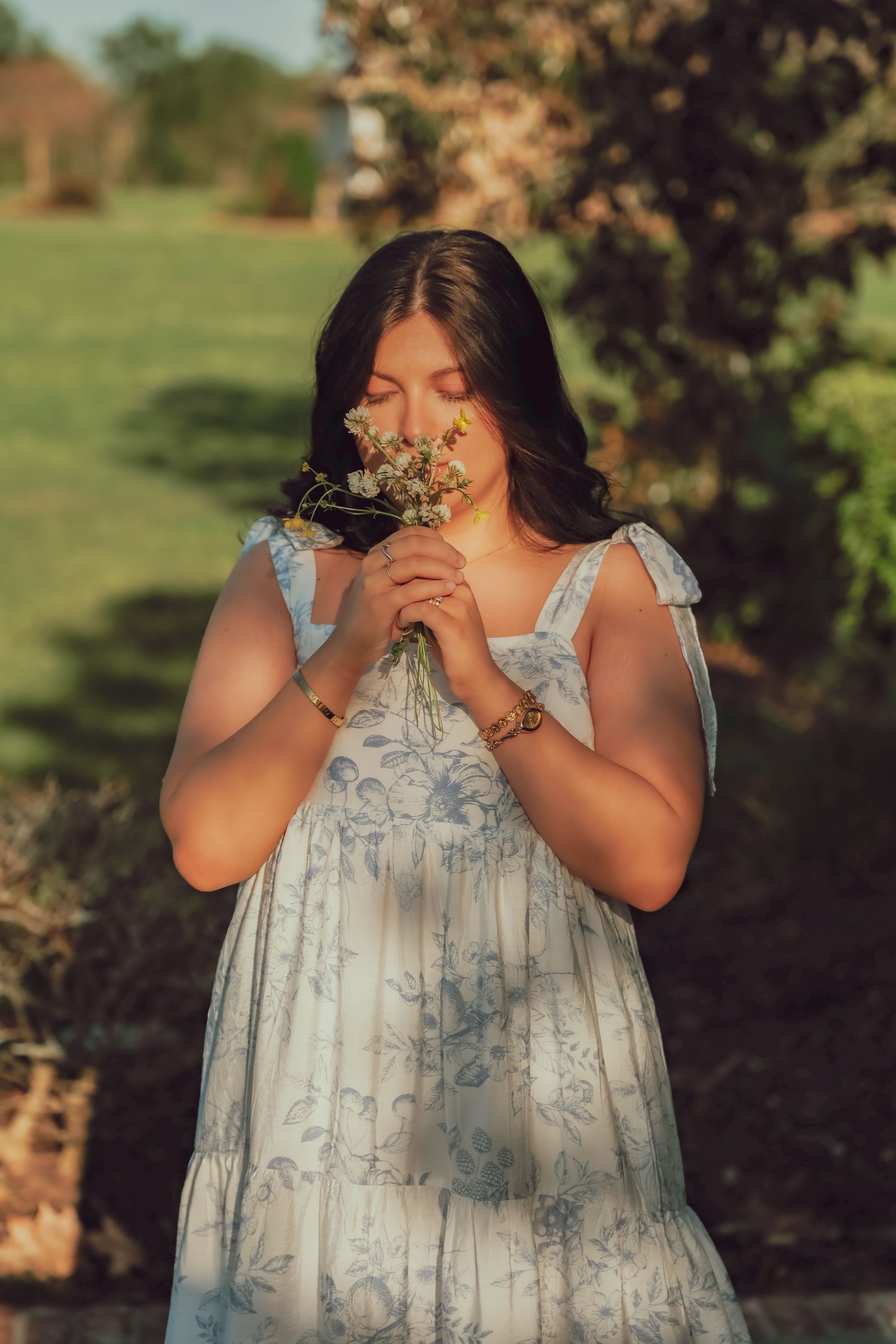Girl hold and smelling flowers senior portrait photography Lafayette