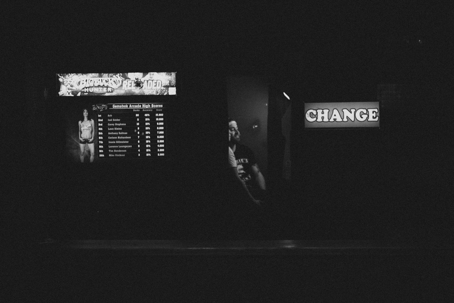 Dark urban scene with illuminated 'CHANGE' sign and scoreboard visible.