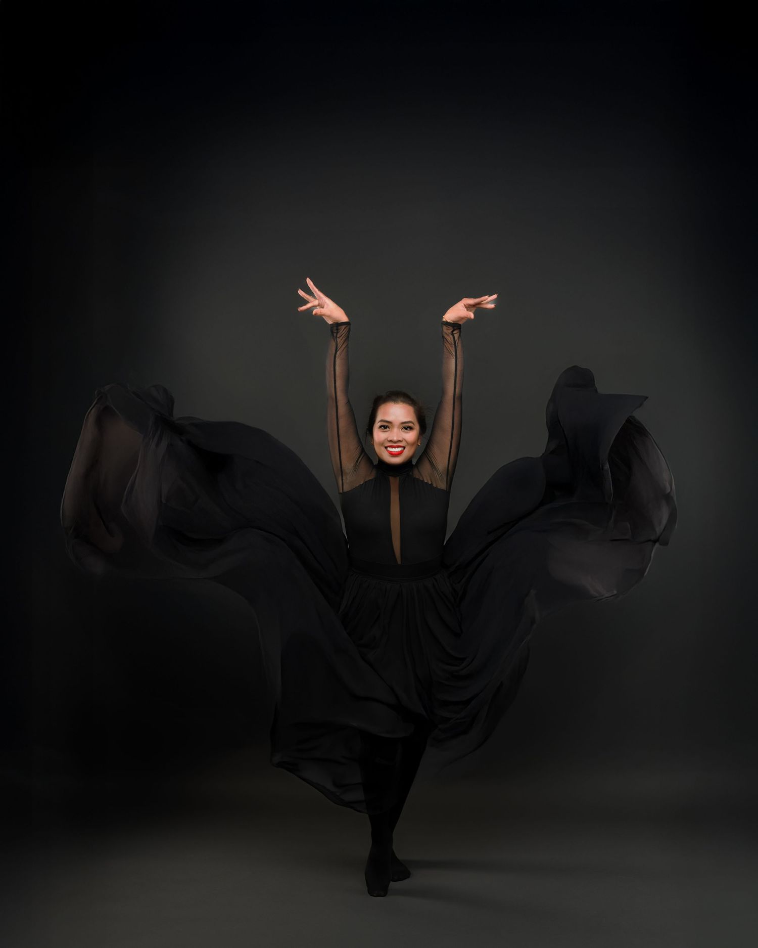 A sequence of dramatic dance poses captured in dark silhouette against a moody black background.