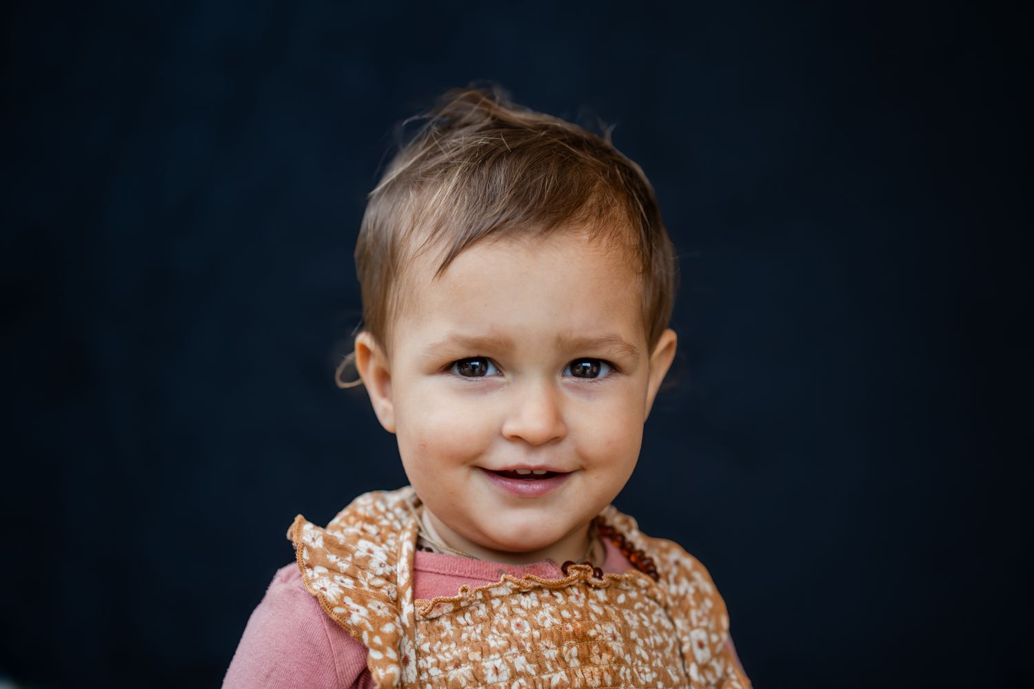young baby girl with dark sparkly eyes portrait