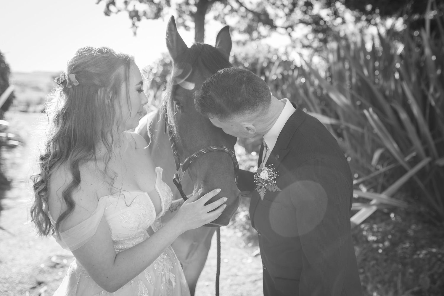 A black and white wedding photo collage showing intimate moments between couples during their celebration.