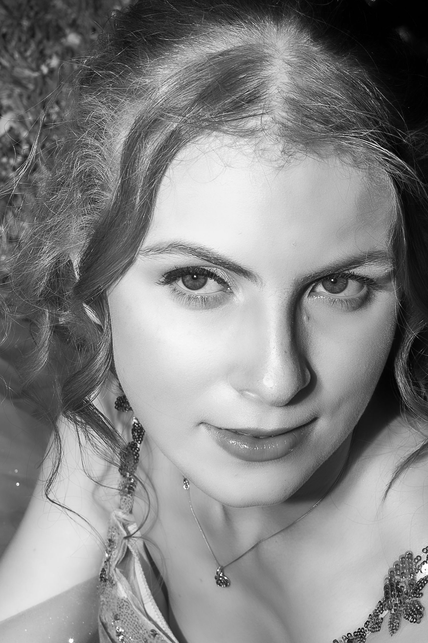 A black and white photo series showing close-up portraits with dramatic lighting and expressive eyes.