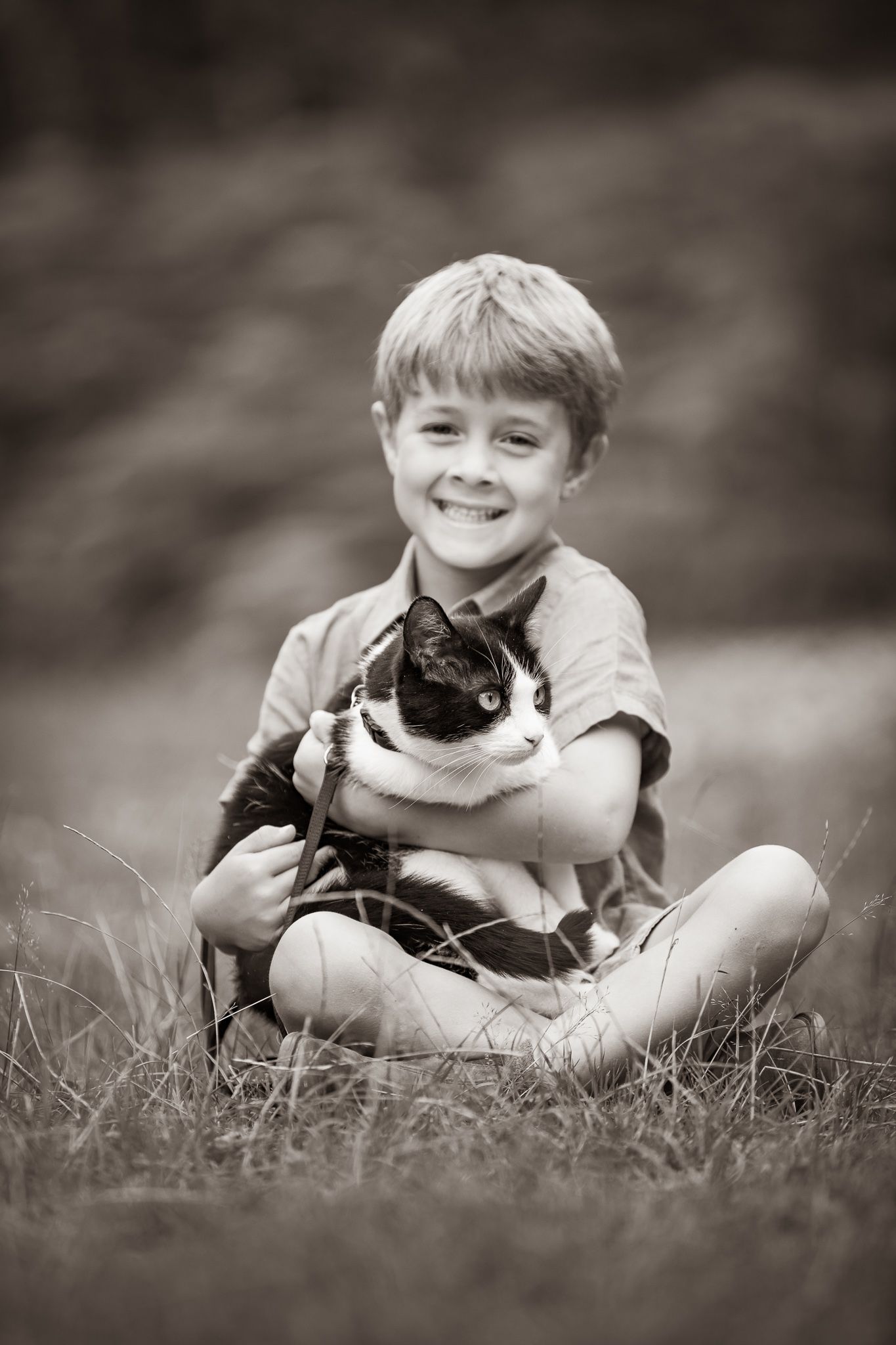 Young equestrian poses with palomino pony in a series of natural outdoor portraits showing their special bond.