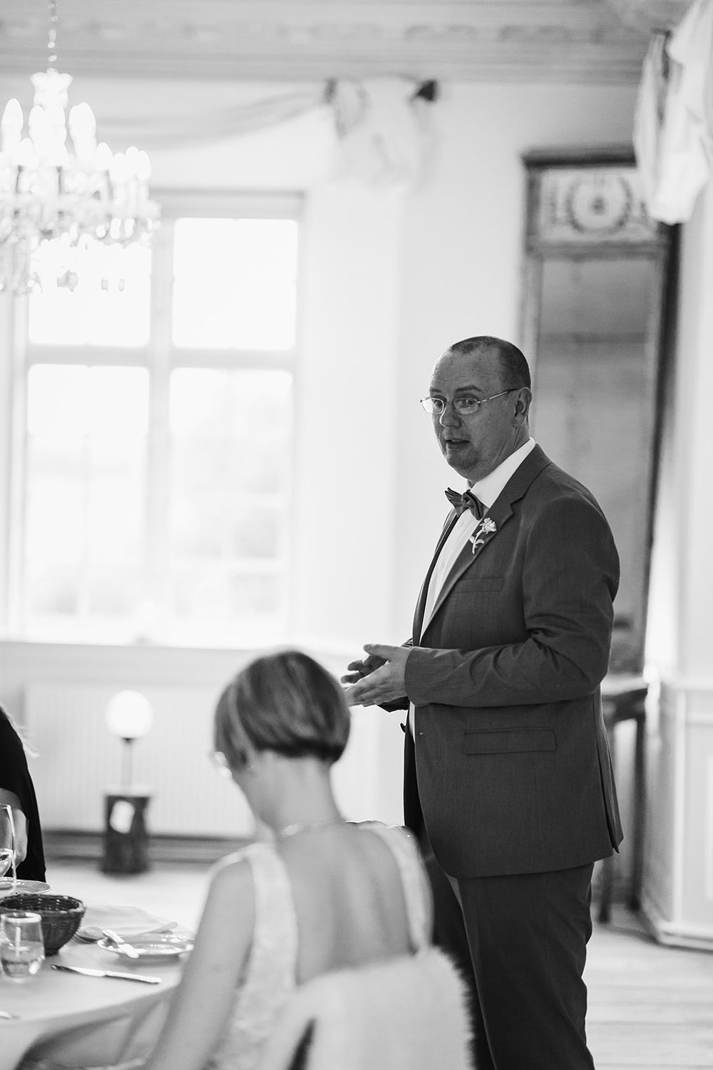 Wedding reception candid moments captured in black and white photography.