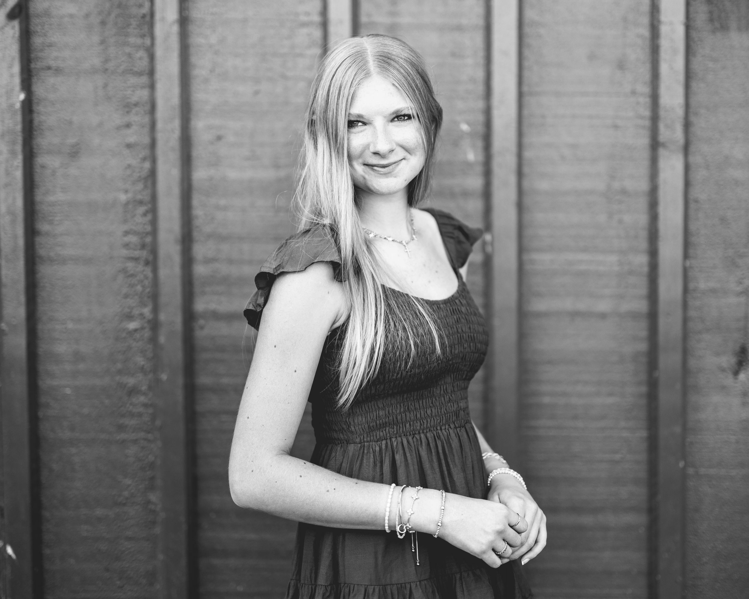 Black and white portrait series against wooden wall background.