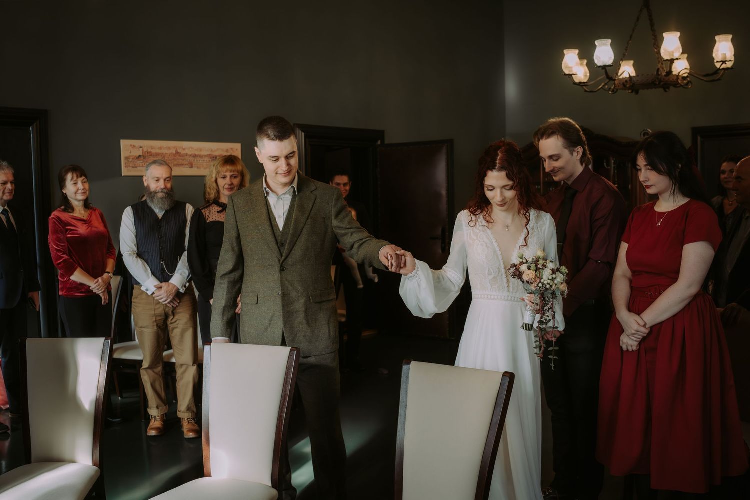 Wedding party members in formal attire gather for candid moments during a reception celebration.