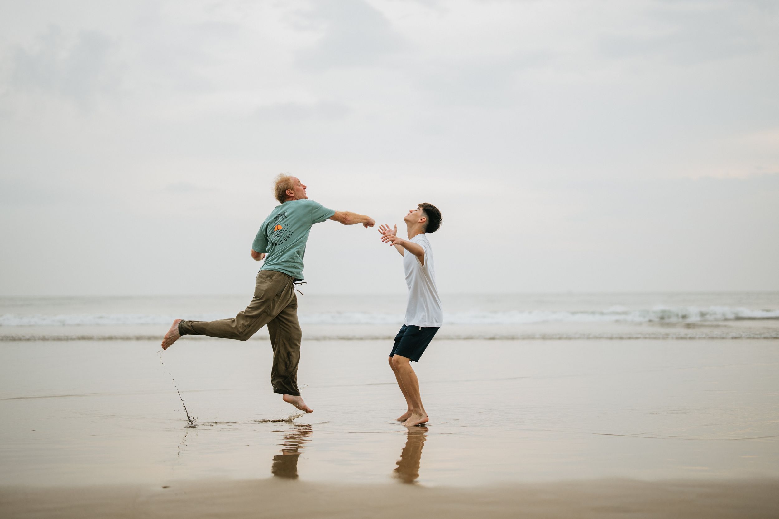 Beach family photography in Bali with an 
ocean backdrop