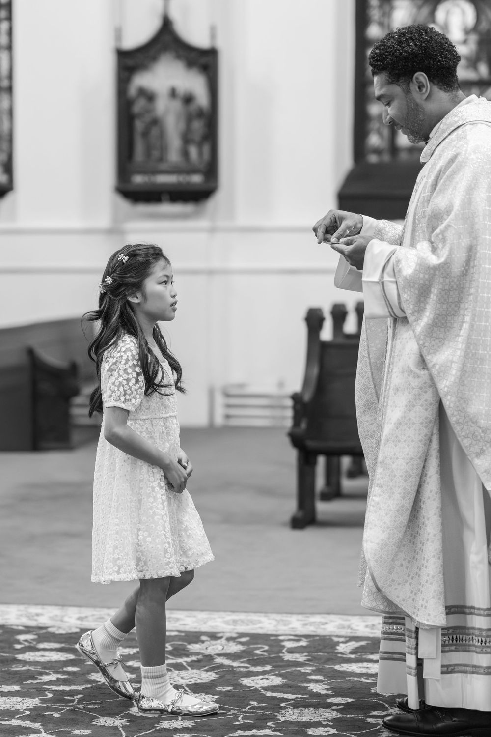 Black and white photo of a religious ceremony with flowing white garments.