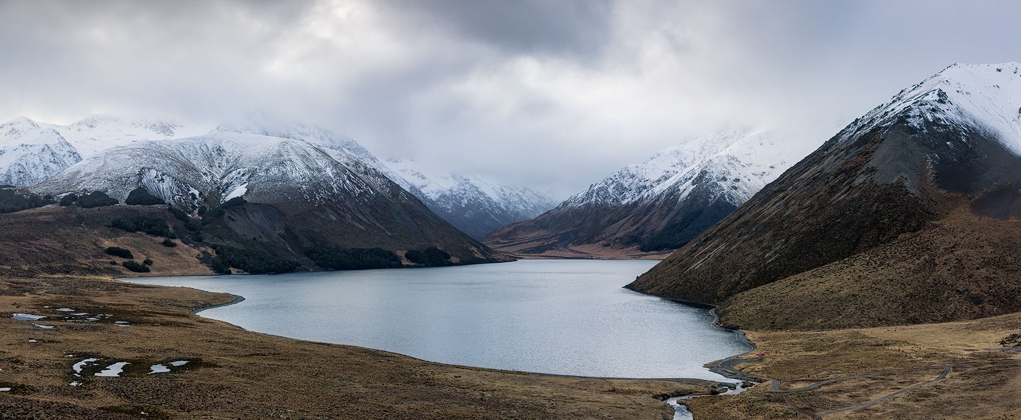 Lake Tennyson, St James Conservation Area. snow  capped mountains above high country lake