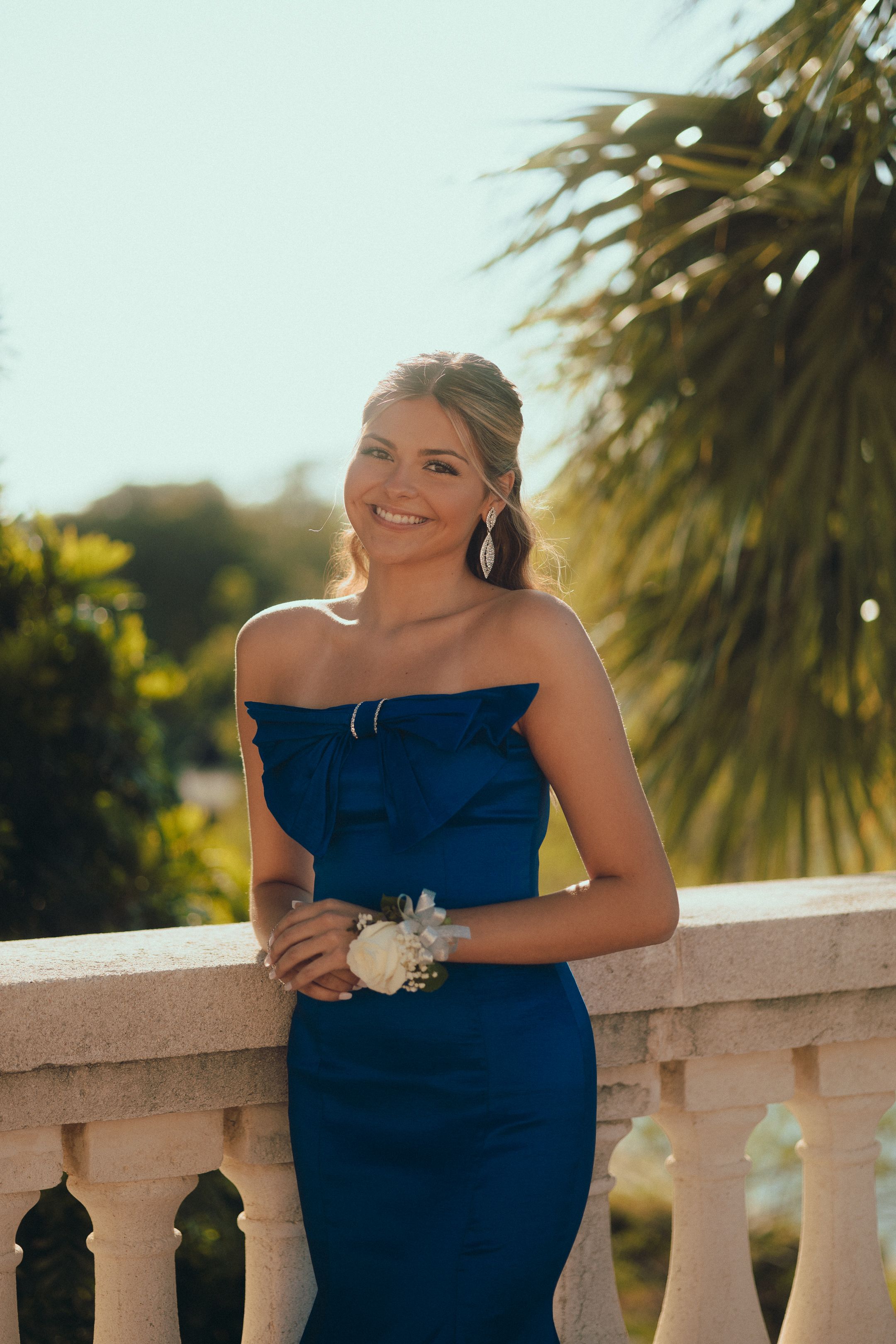 Classic blue gown portrait with palm trees, Miami prom photography by Mannyportraits, South Florida cinematic style for teens + seniors.