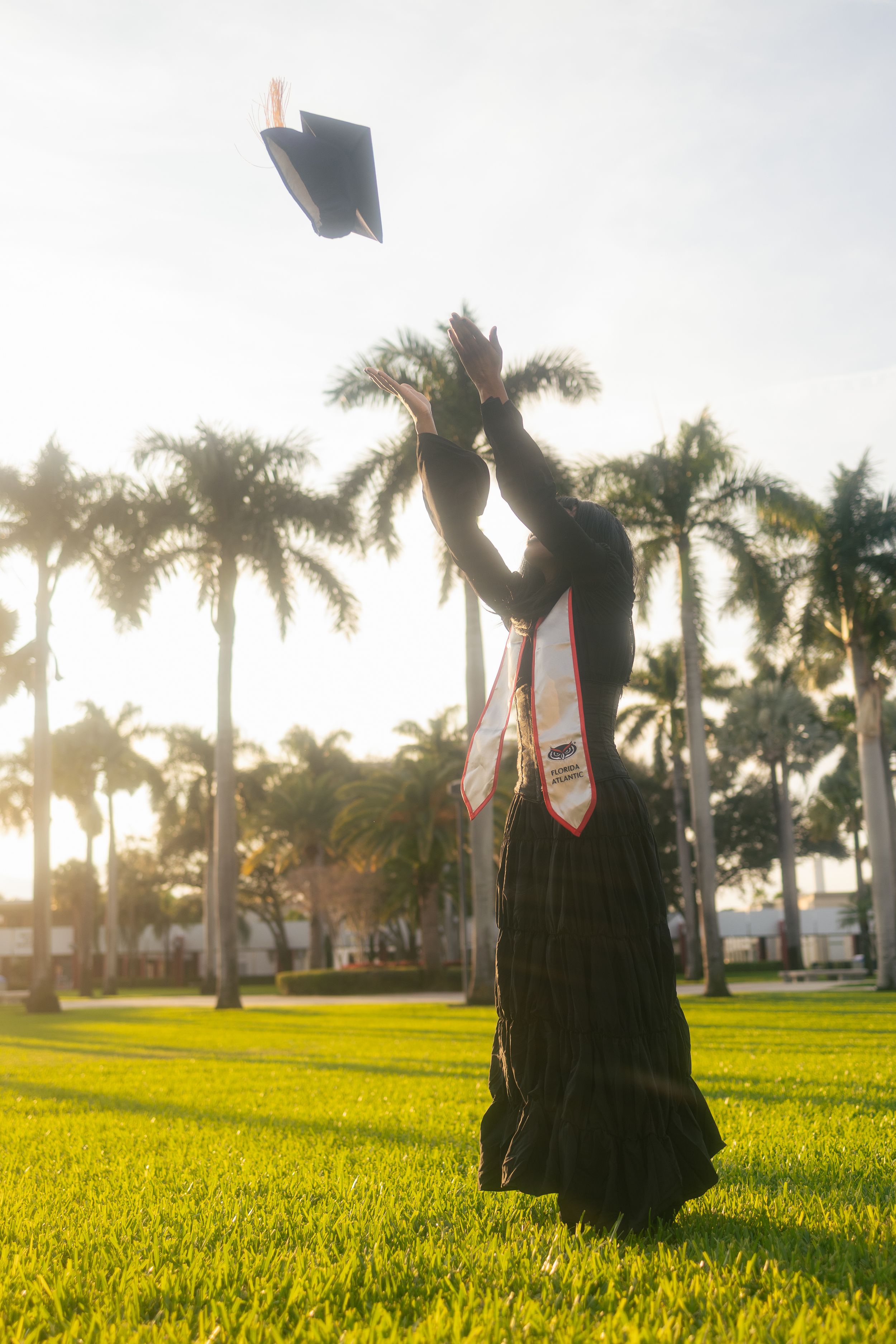Miami graduation portrait at golden hour with palm trees. FIU, UM, FAU senior photos by MannyPortraits in South Florida.