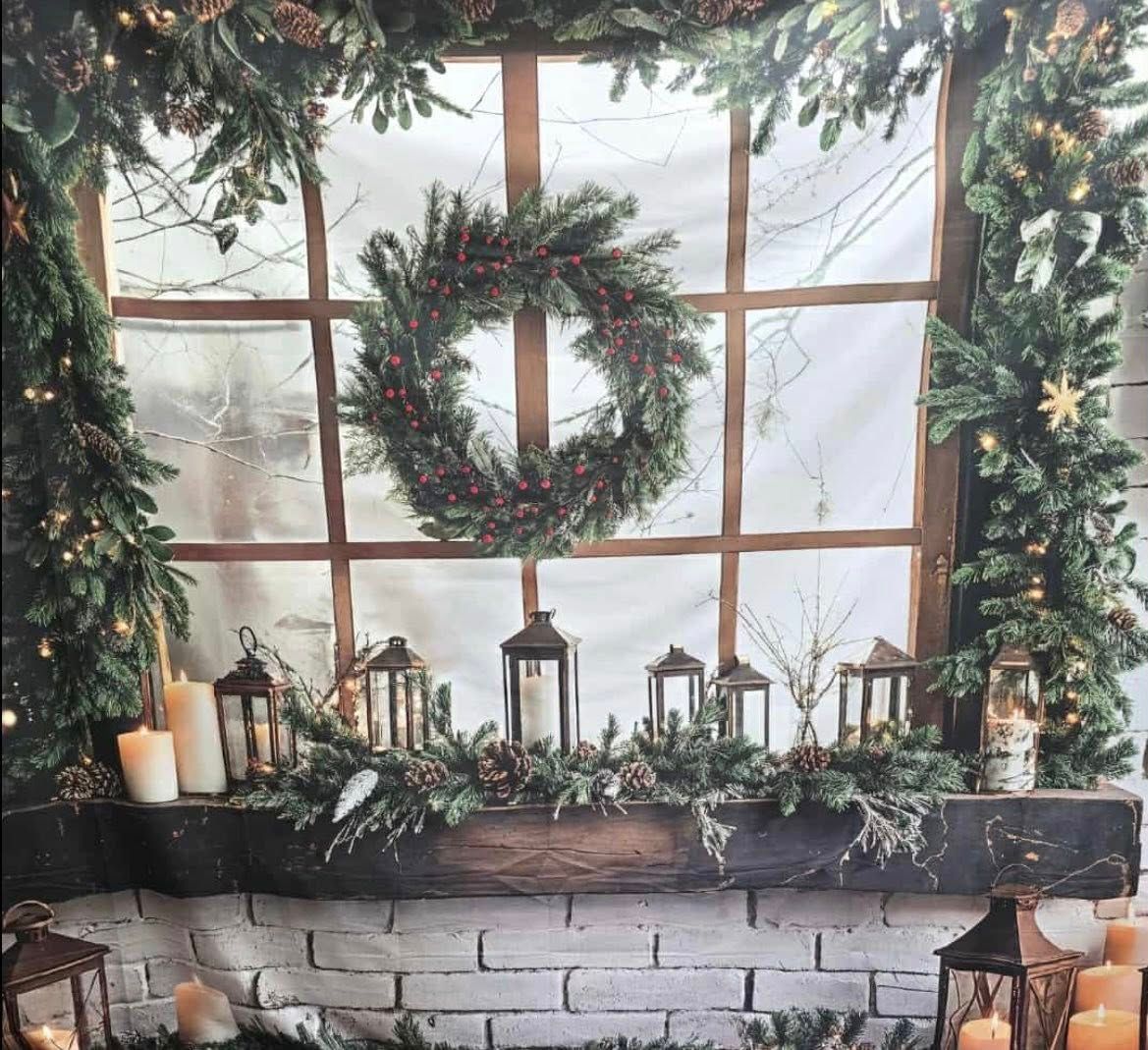 Christmas themed backdrop with lit trees and snowy path through decorated entrance gate.