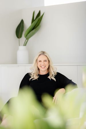 Stylish portrait with indoor plants and white vase in minimalist setting.