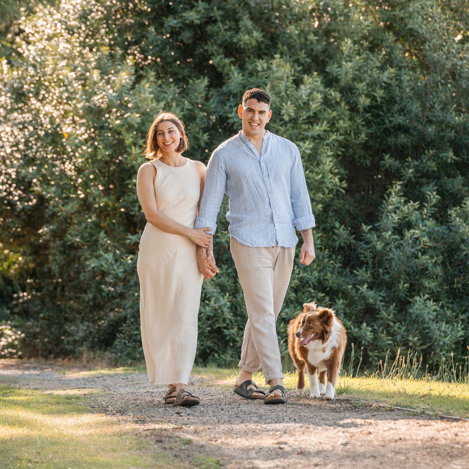 couple-walking-towards-a-camera-in-the-park-with-their-border-collie-during-a-photoshoot-in-Sydney-inner-west