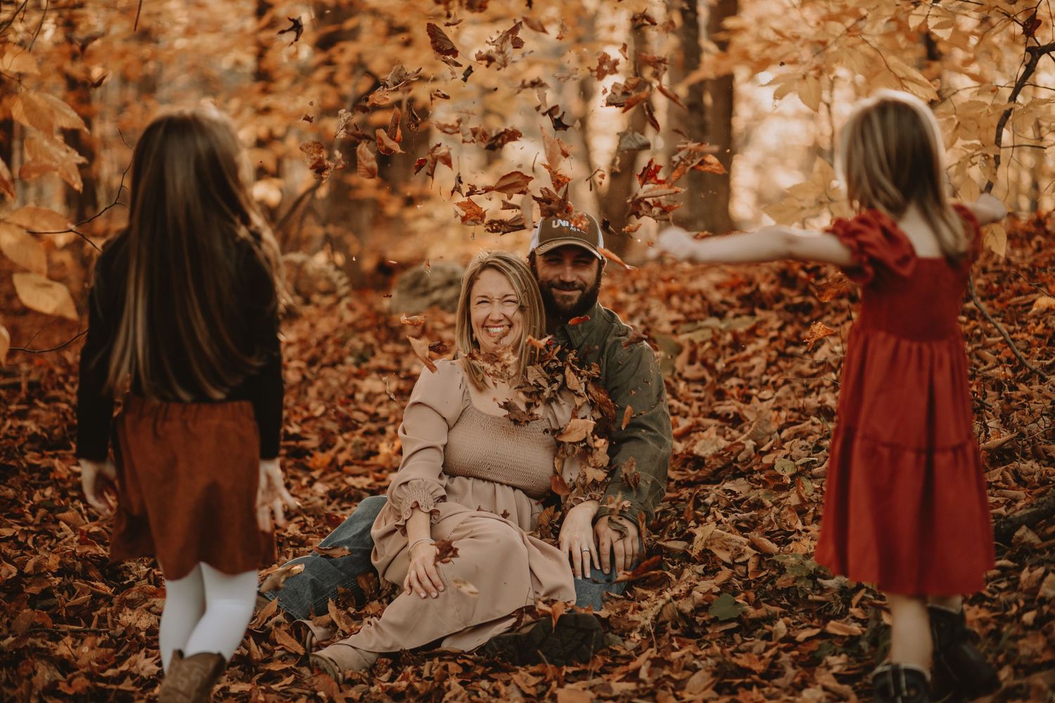 Autumn scene with falling leaves and family enjoying the seasonal colors.