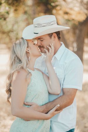 A tender embrace captured between a couple in western attire during their engagement session.
