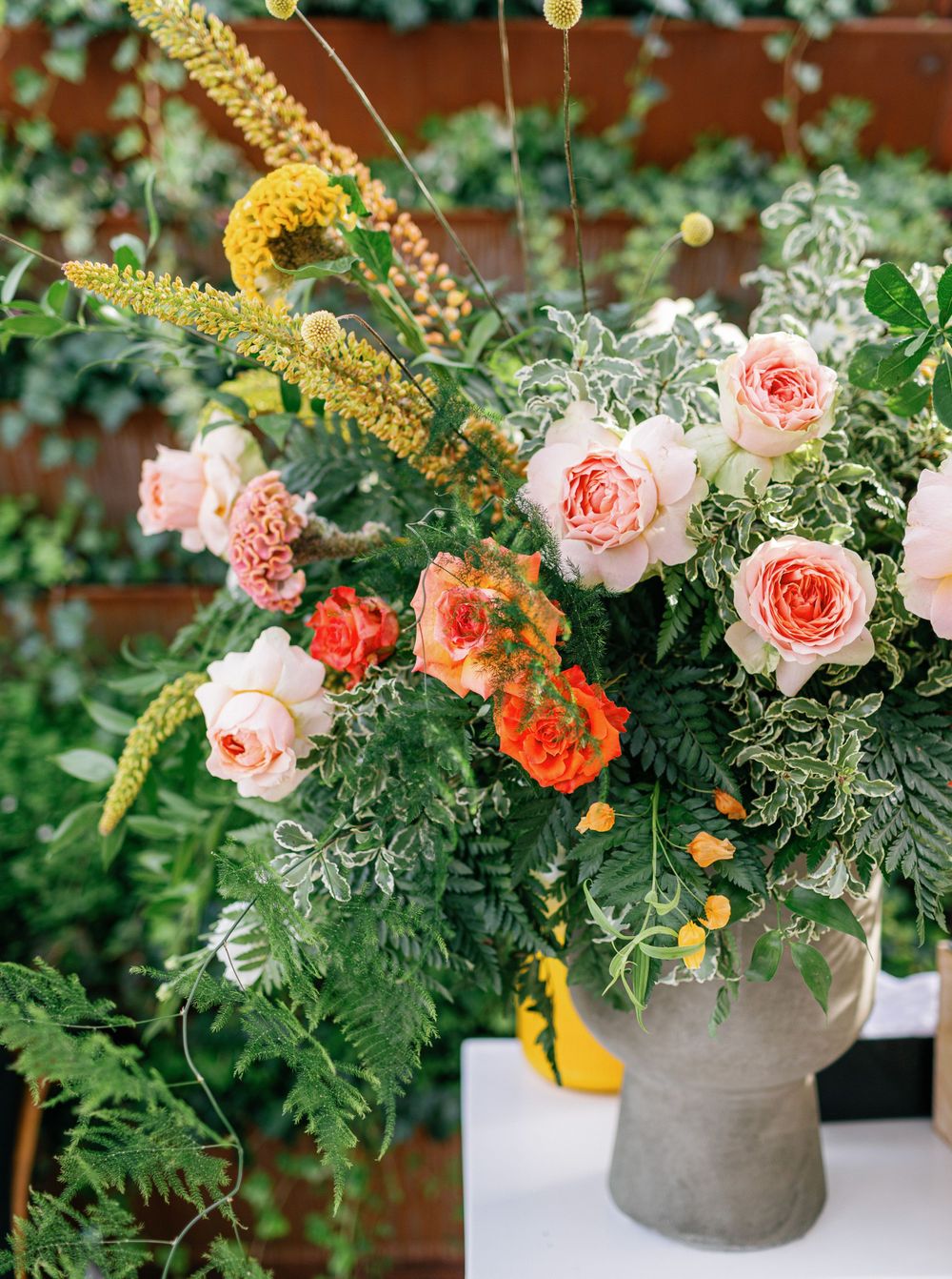 Colorful floral arrangement with pink and orange roses at a wedding in Six Senses Douro Valley, Portugal.