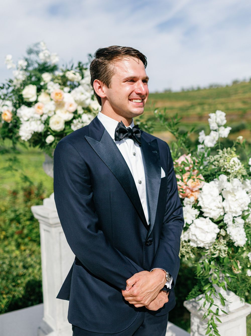 Groom smiles in anticipation at Six Senses Douro Valley wedding.