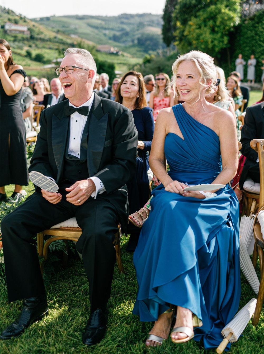 Guests smile and laugh during the wedding ceremony at Six Senses Douro Valley.