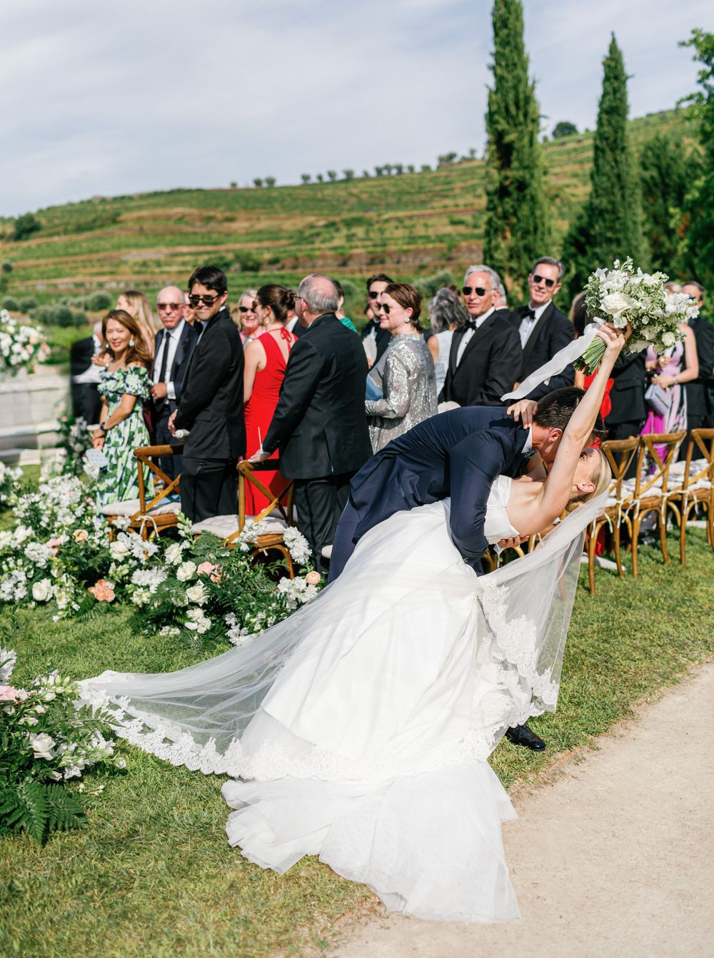 Bride and groom share a romantic kiss at the end of the aisle at Six Senses Douro Valley.