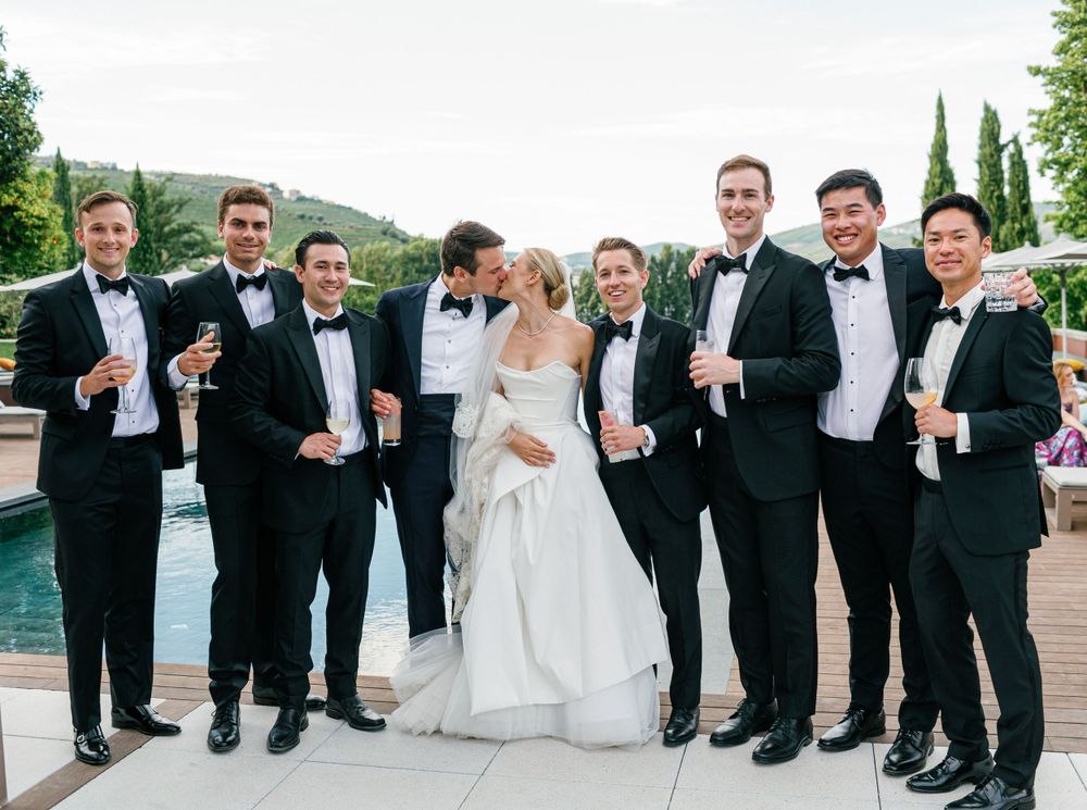 oyful moment of the bride and groom with the groom’s friends, celebrating with drinks at cocktail hour.
