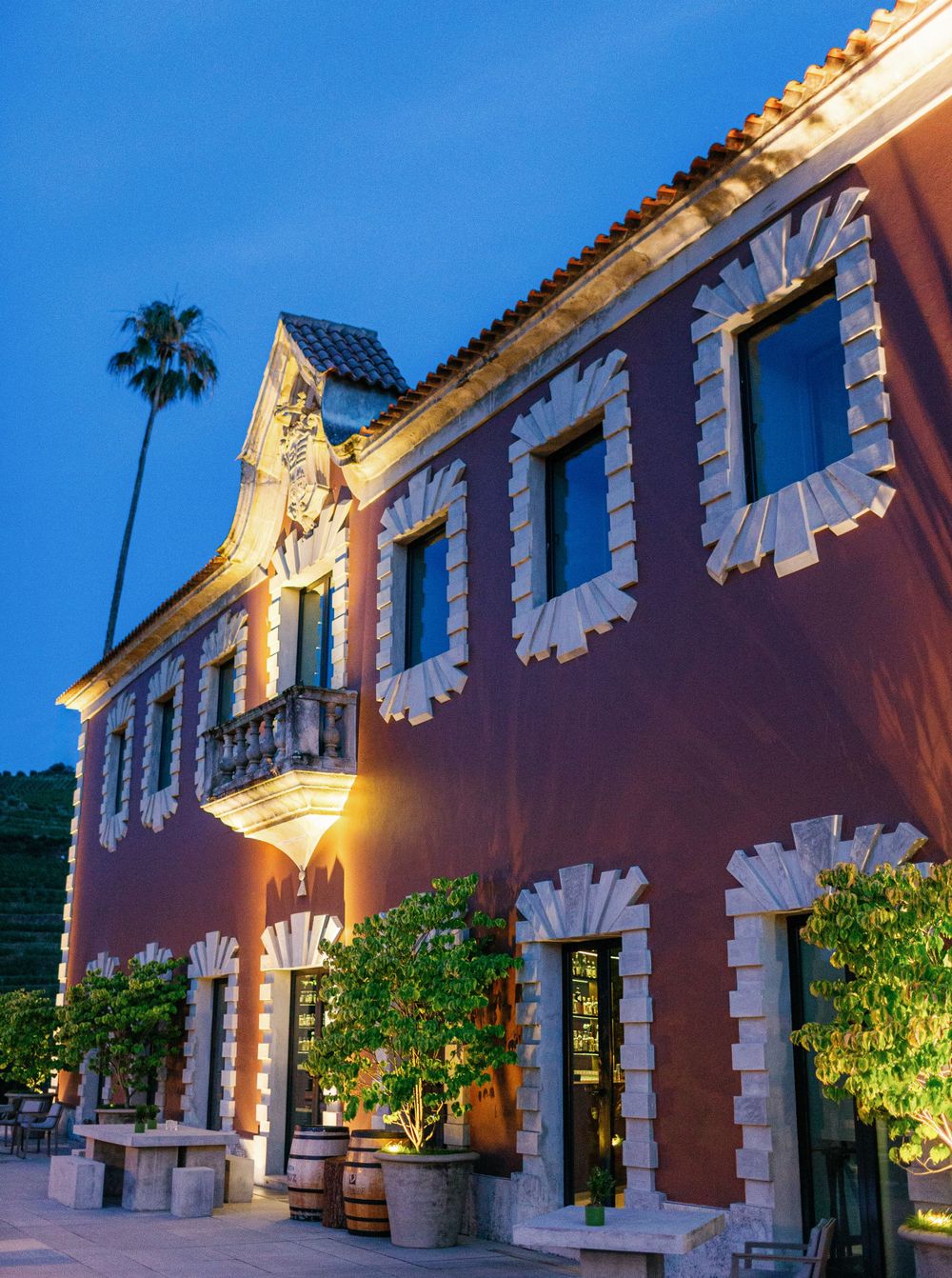 Exterior view of Six Senses Douro Valley wedding venue at night.