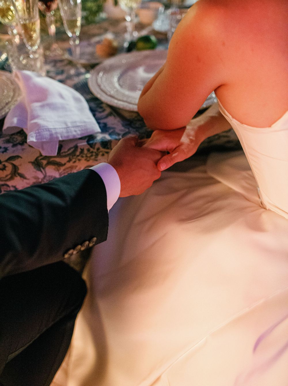 Bride and groom holding hands at their wedding reception, Six Senses Douro Valley.