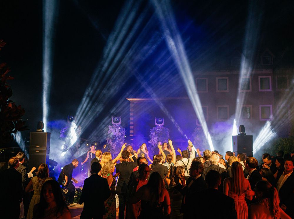 Guests dancing under dramatic lighting during the wedding celebration, Six Senses Douro Valley.