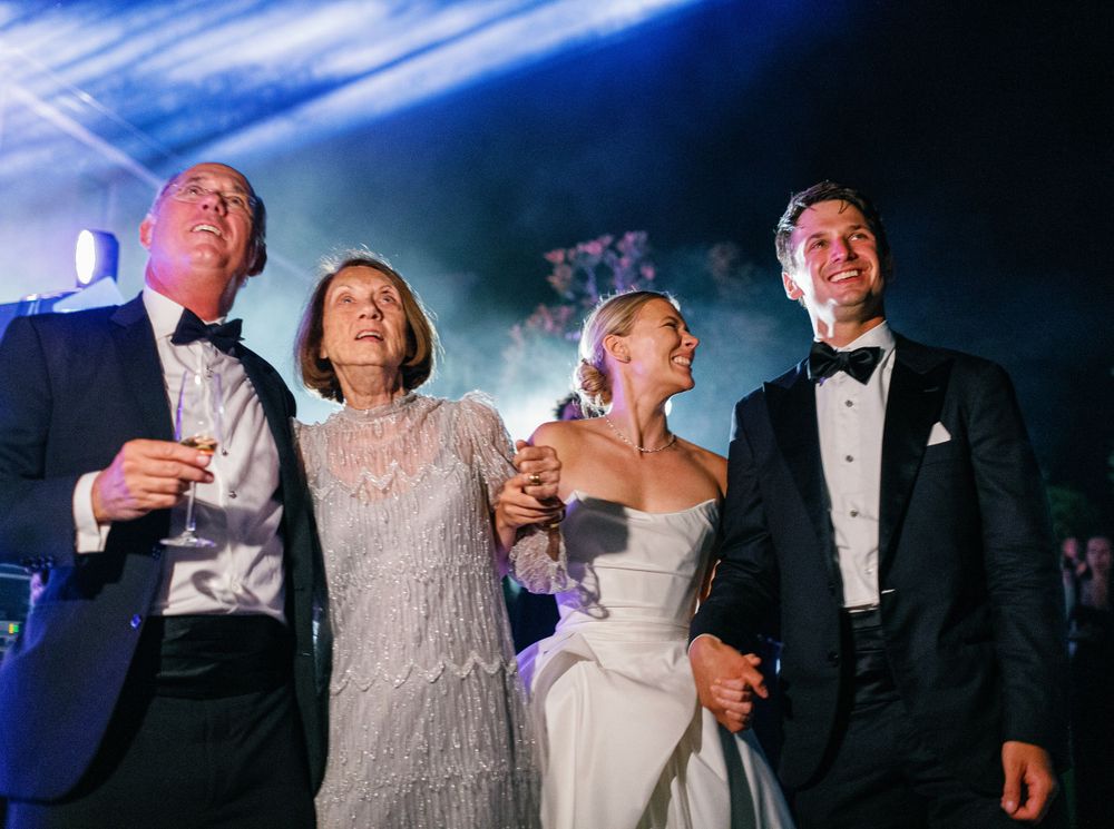 Bride and groom looking at fireworks with family at their Six Senses Douro Valley wedding.
