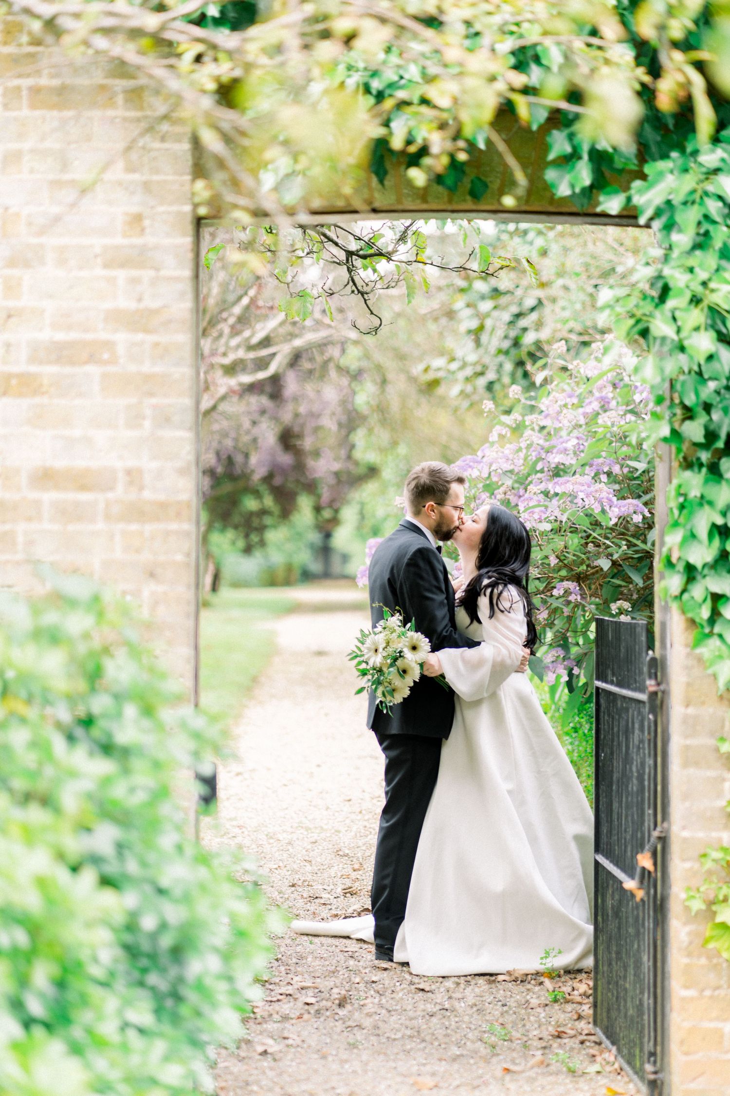 Bride and Groom Kissing in doorway of hidden garden at Wollaton Hall and Deer Park