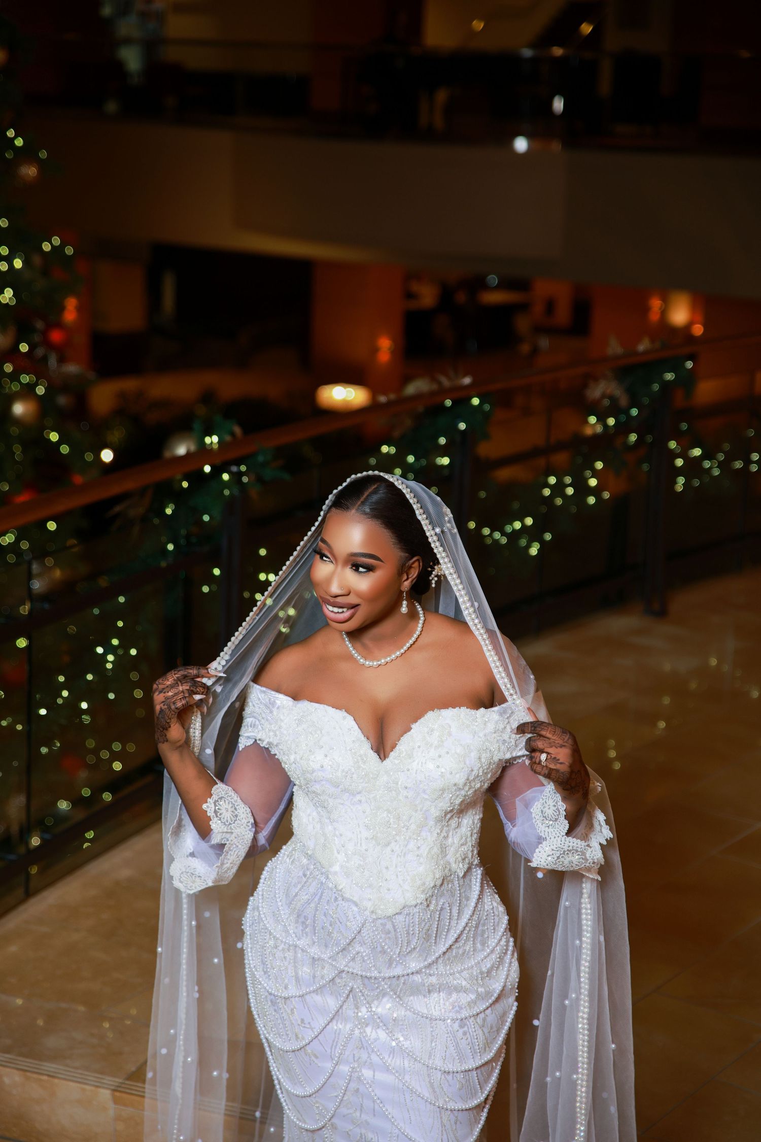Bridal portraits showcasing a detailed white wedding gown with lace veil.