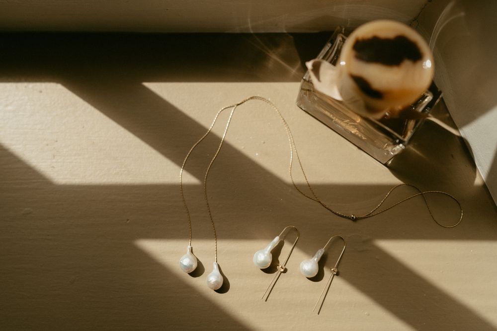 Musical notes made from shadows cast by thread and pins in sunlight on a wooden surface.