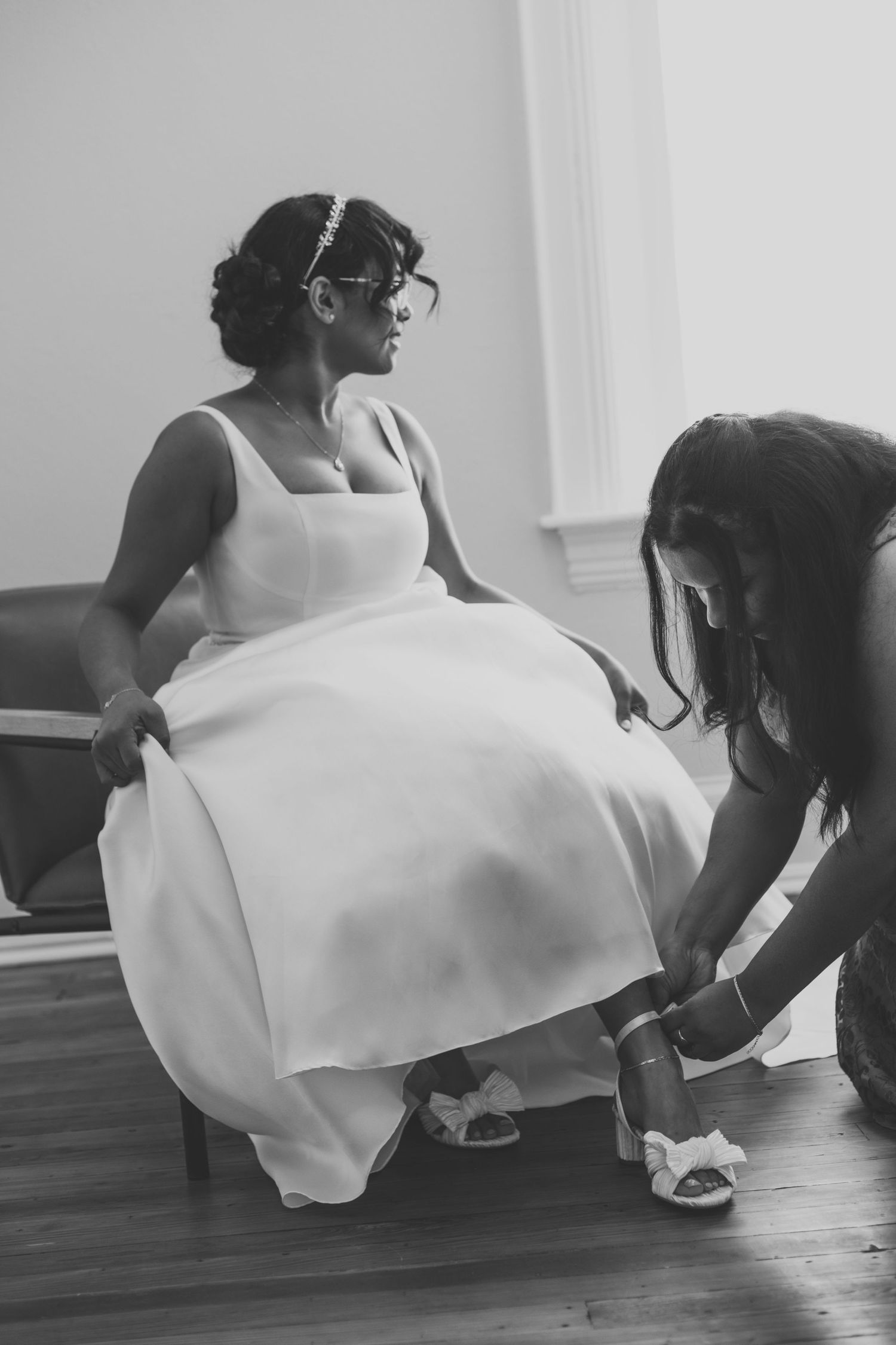 Black and white sequence showing the movement of a flowing white dress against a dark floor.