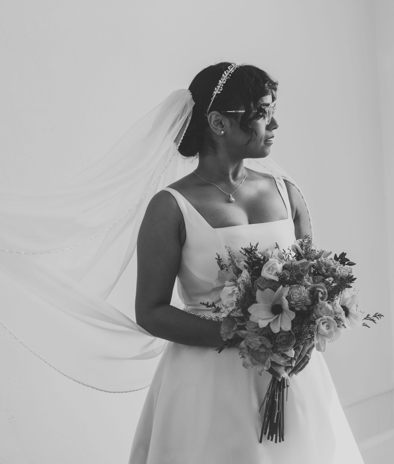 Black and white bridal portraits showing elegant dress and floral bouquet details.