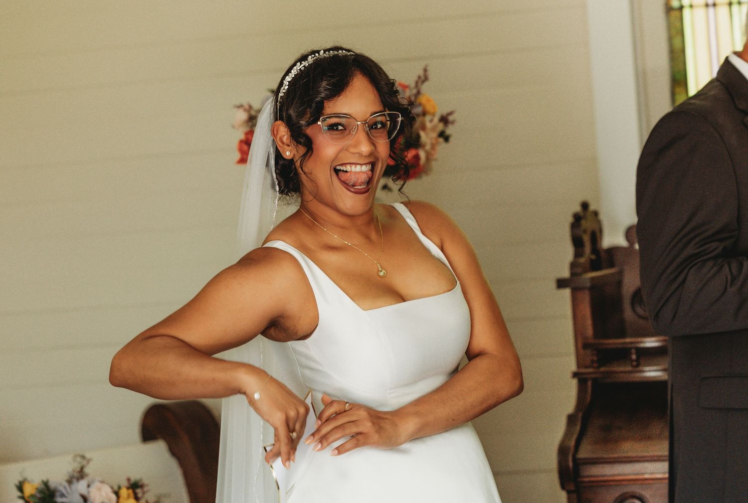 Joyful wedding celebration moment captured indoors with natural lighting.