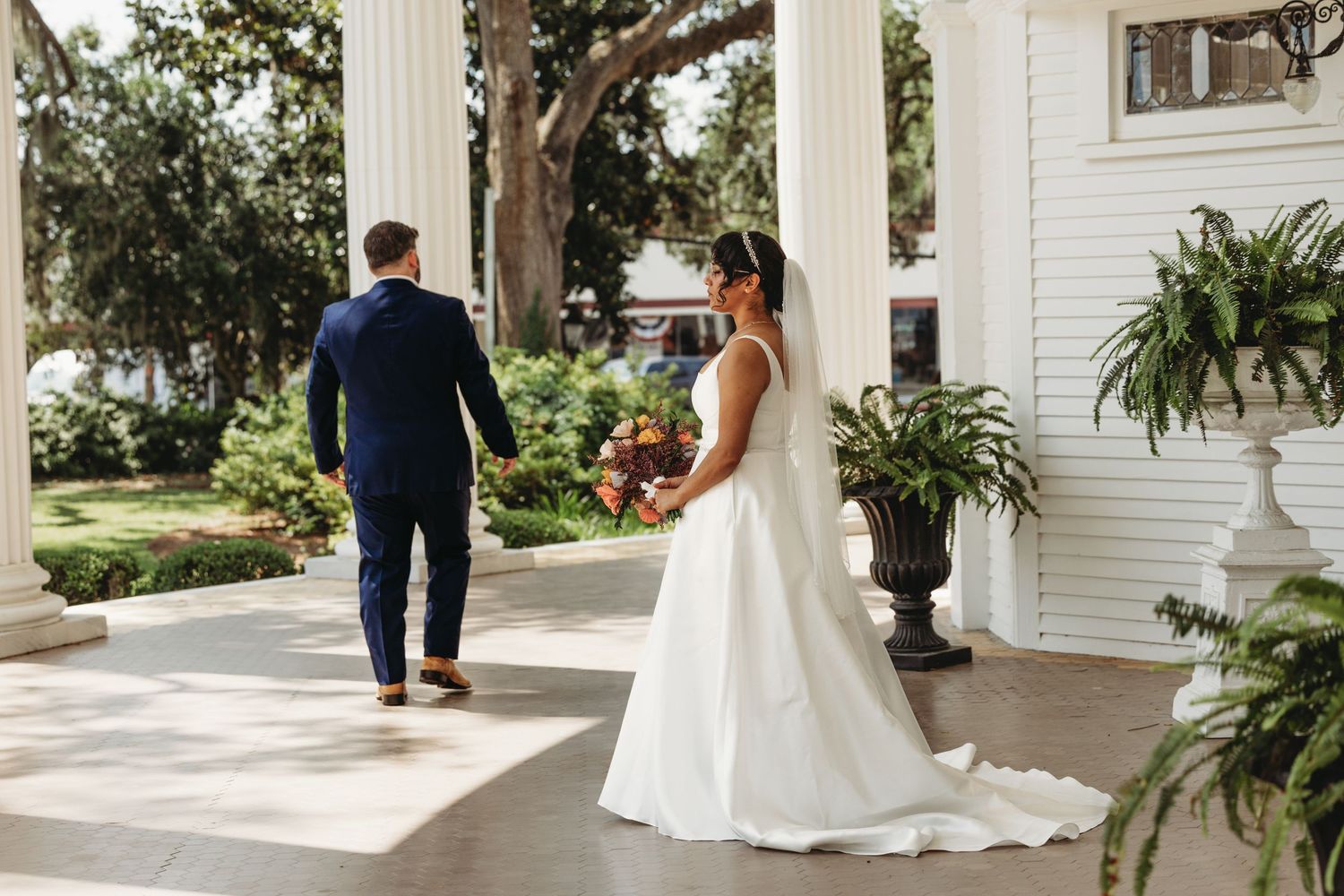 Elegant wedding photography session on a southern plantation-style porch with columns.