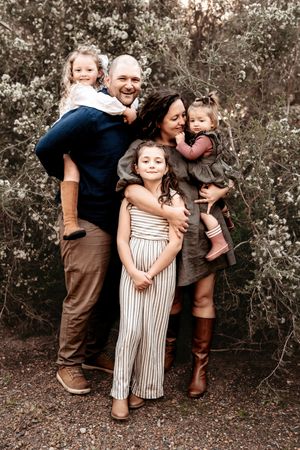 A collection of candid outdoor family portraits showing joyful interactions against a natural backdrop.