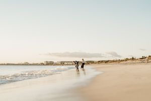 A muted, minimalist series of beachfront photographs showing sandy shores, meandering coastlines and distant figures.
