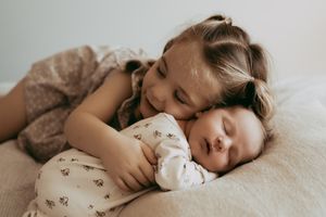 Sleeping baby in soft grey blanket captured from multiple angles in dreamy lifestyle photography series.