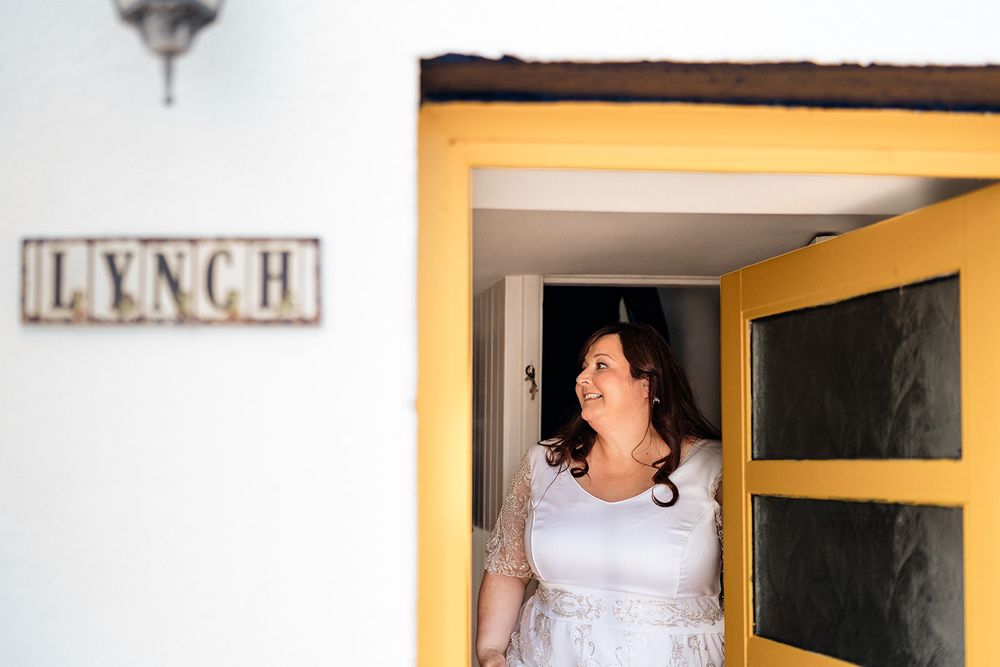 Wedding preparations and decorative details with framed photos and decor signs on cream colored walls.