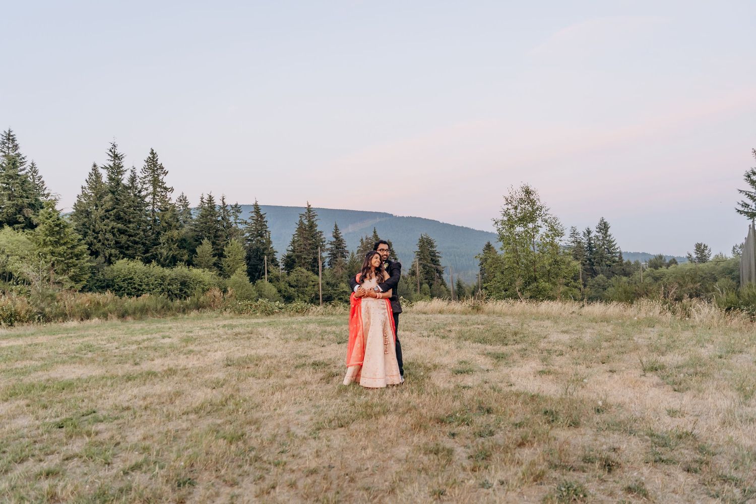 Scenic mountain landscape with evergreen trees serving as backdrop for an outdoor wedding.