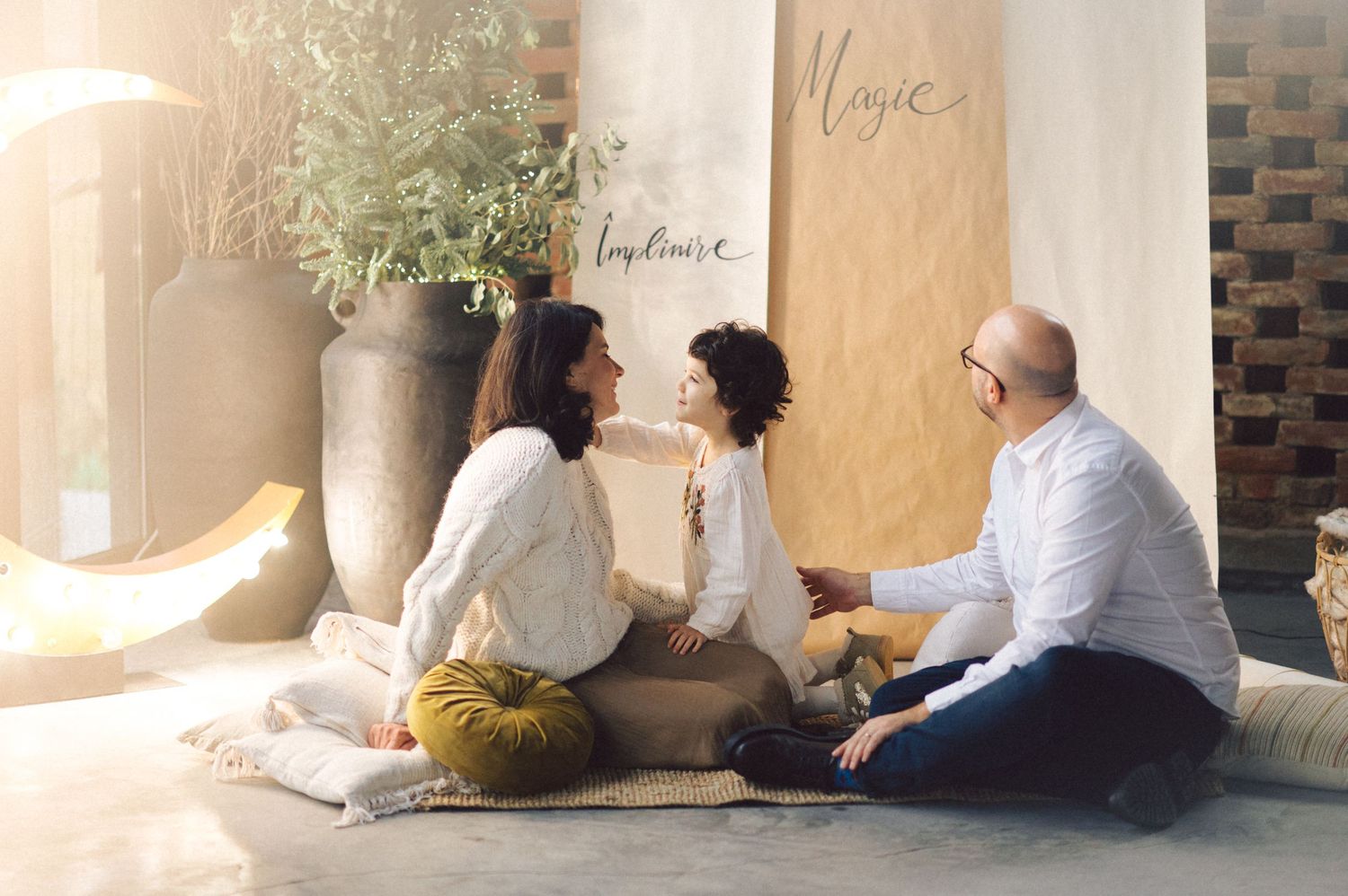 People sitting together looking out at a panoramic view through arched stone windows in an ancient building.
