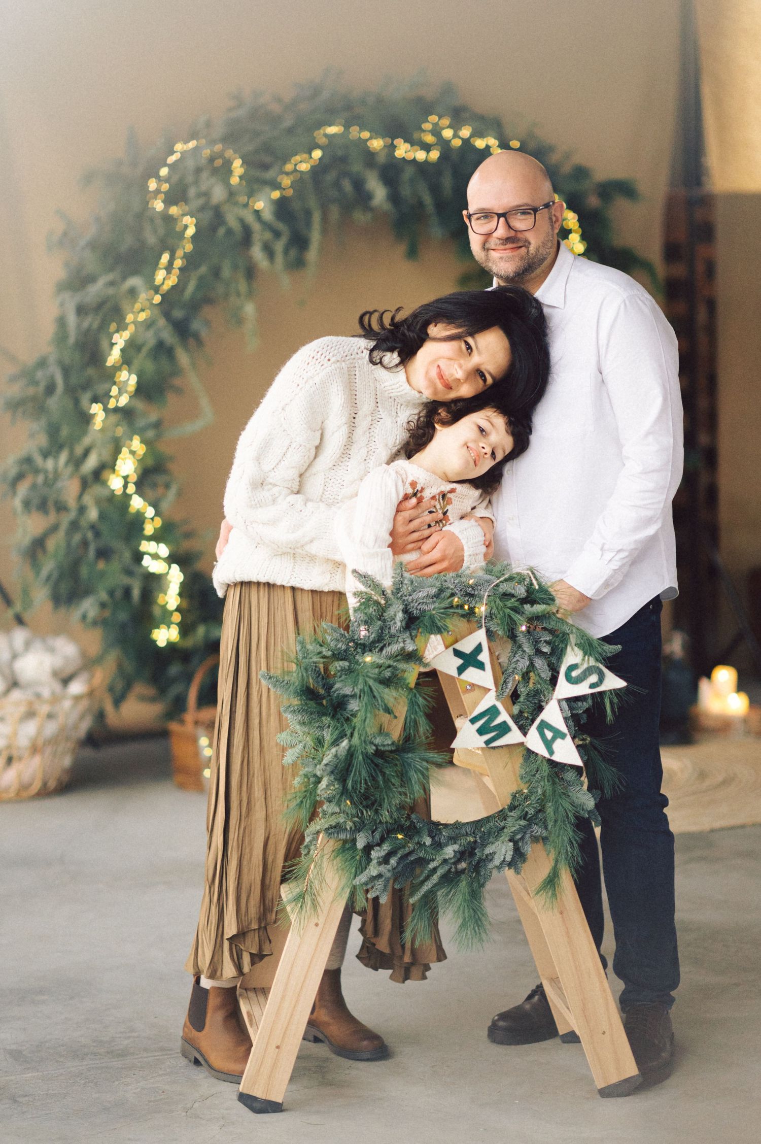 A creative photo sequence showing a wreath being used as a modern dance prop in an indoor setting with warm lighting.