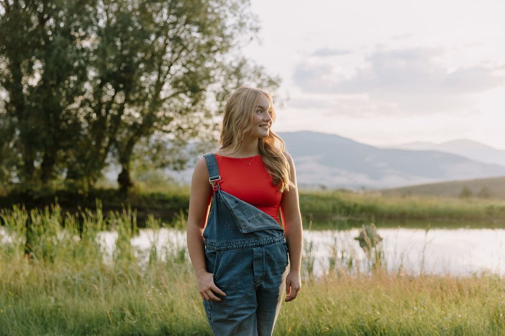 Rural countryside photoshoot with mountains and fields in golden evening light.