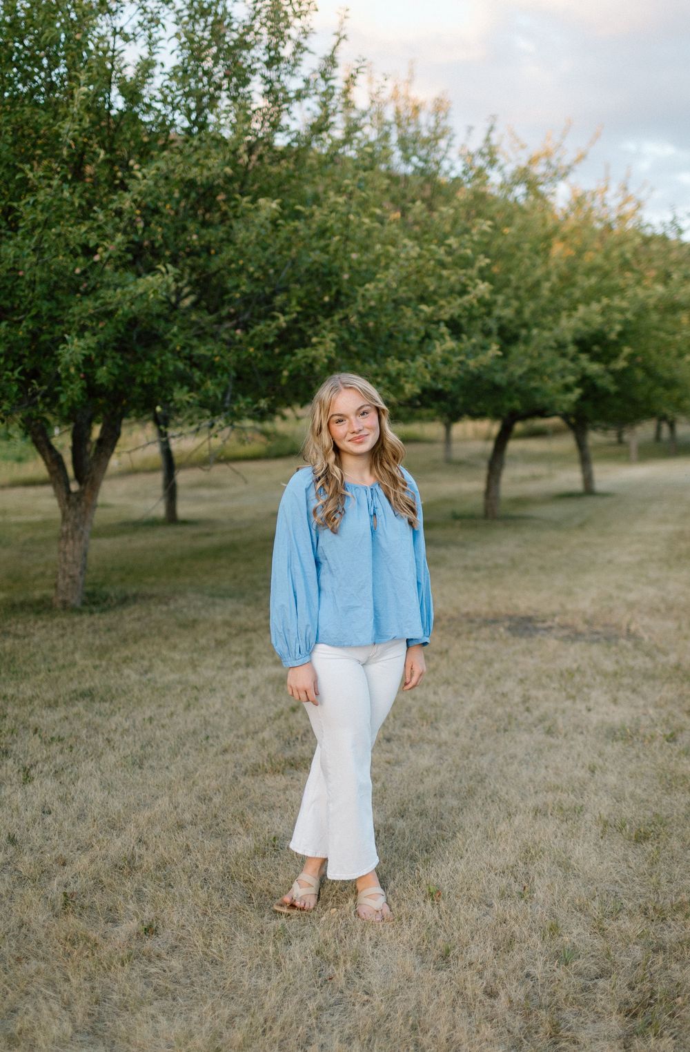 Casual portrait session in an orchard during golden hour.