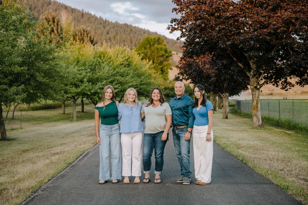 Family group photo taken on a path surrounded by trees and nature.