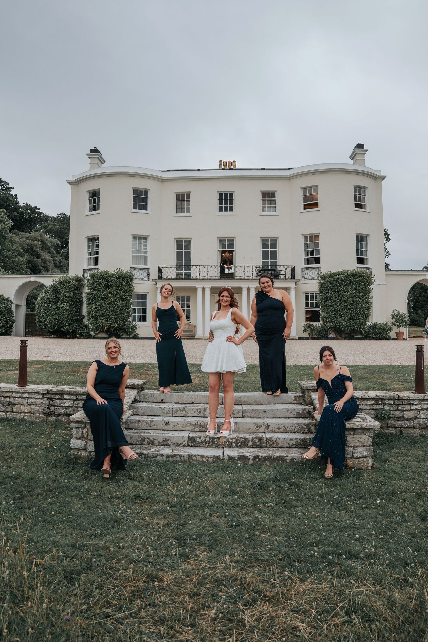 Group portraits with bridesmaids in front of Rockbeare Manor entrance