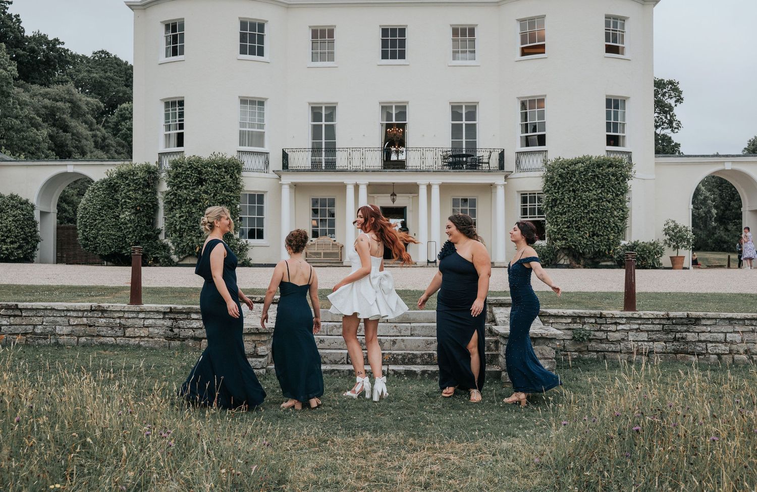 Group portraits with bridesmaids in front of Rockbeare Manor entrance