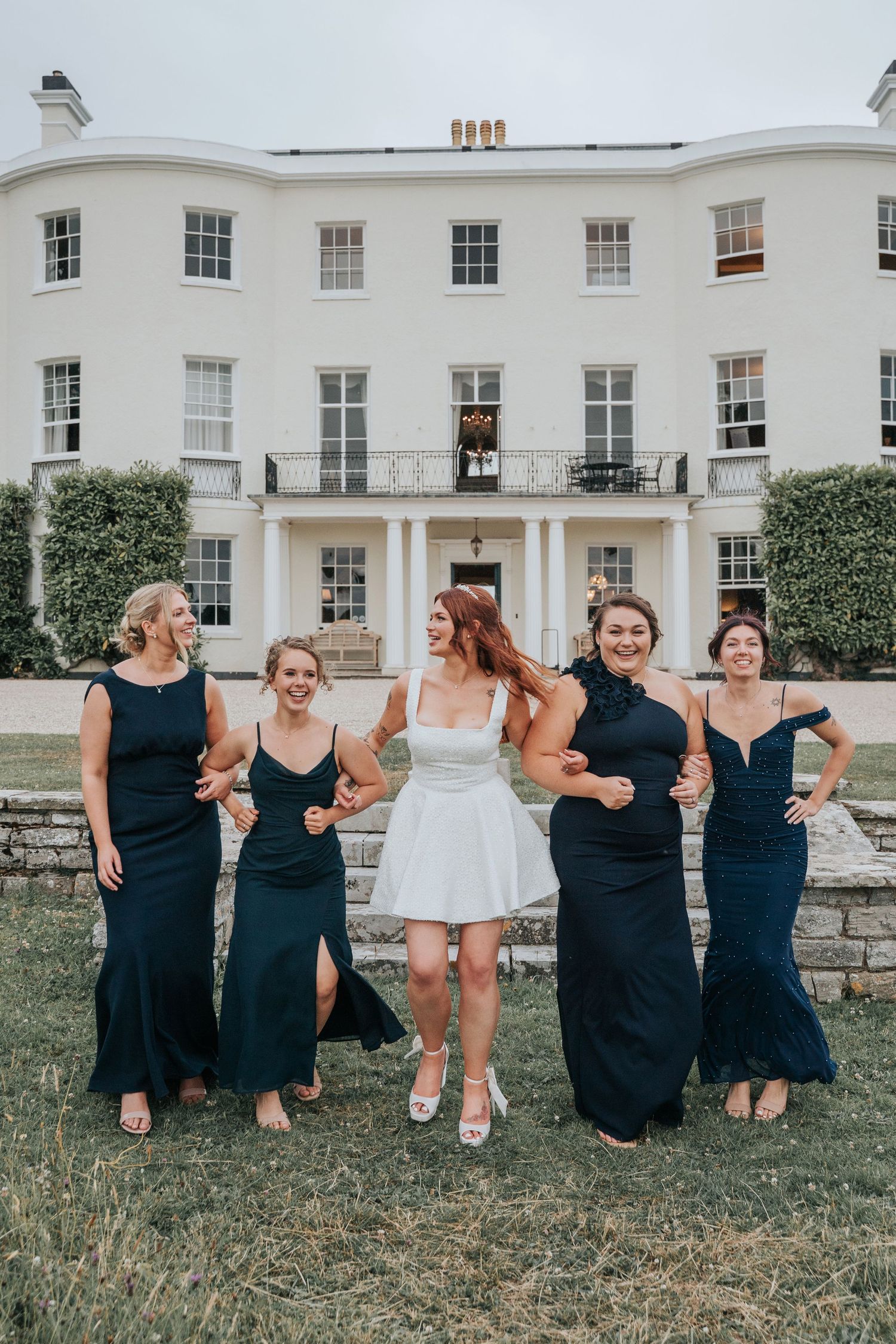 Group portraits with bridesmaids in front of Rockbeare Manor entrance