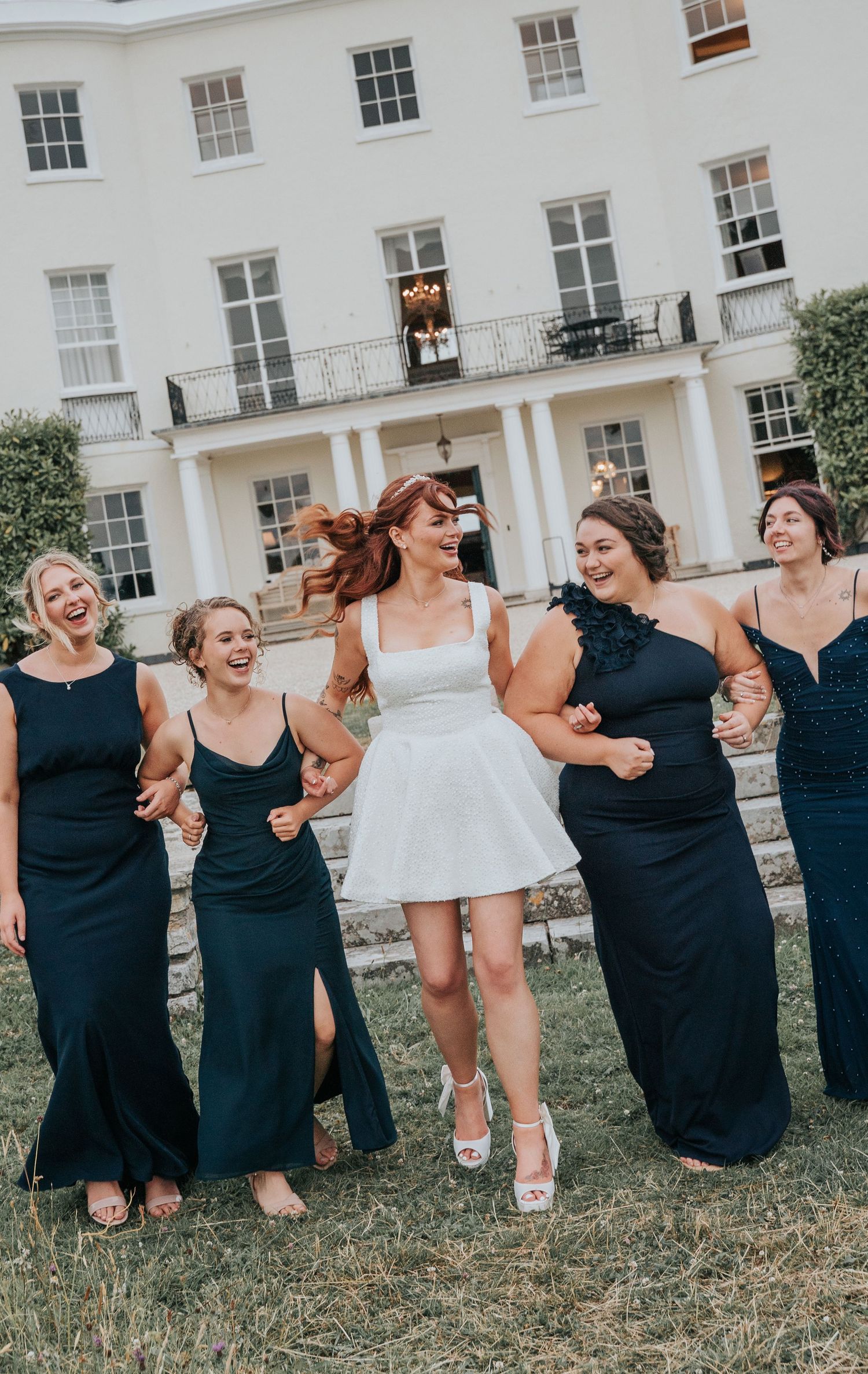Group portraits with bridesmaids in front of Rockbeare Manor entrance